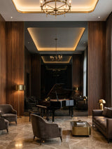 Black Mirror wood veneer panel feature wall reflecting a grand piano in a contemporary music lounge