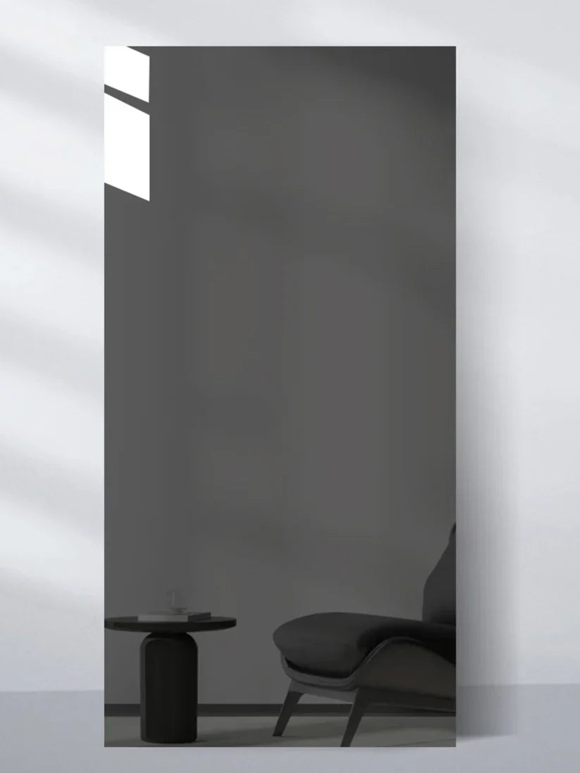Gray glossy wood veneer wall panel sample reflecting a lounge chair and round side table