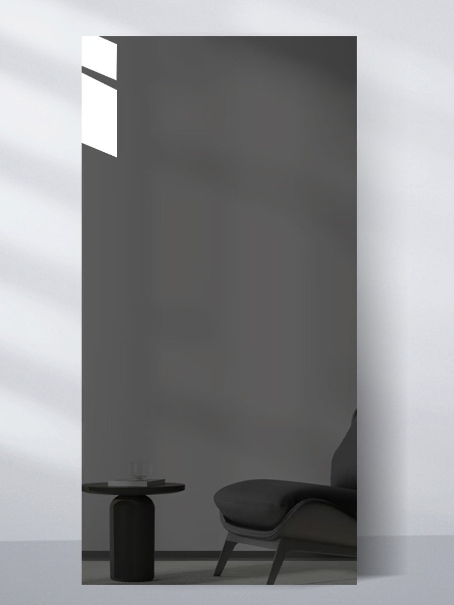 Gray Mirror Wood Veneer Panel in 9 x 4 ft size reflecting a dark lounge chair and side table