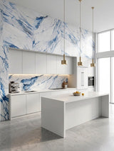 Bright modern kitchen with blue-veined Calacatta Azur PVC wall panels, white cabinetry and island