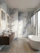 Bright bathroom lined with Frosted Sky marble-look PVC wall panels around the vanity, shower, and tub