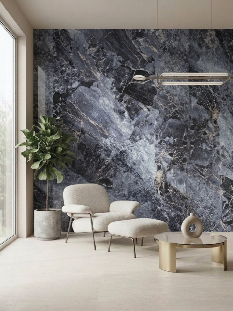 3D Zena black marble PVC wall panel installed behind a cream lounge chair and potted plant