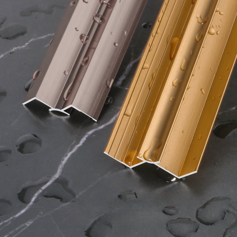 Silver and gold 3mm aluminum inside corner trims with water droplets on dark marble