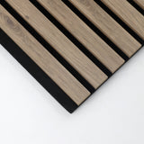 Corner detail of white acoustic wood slats with finished edges on black backing