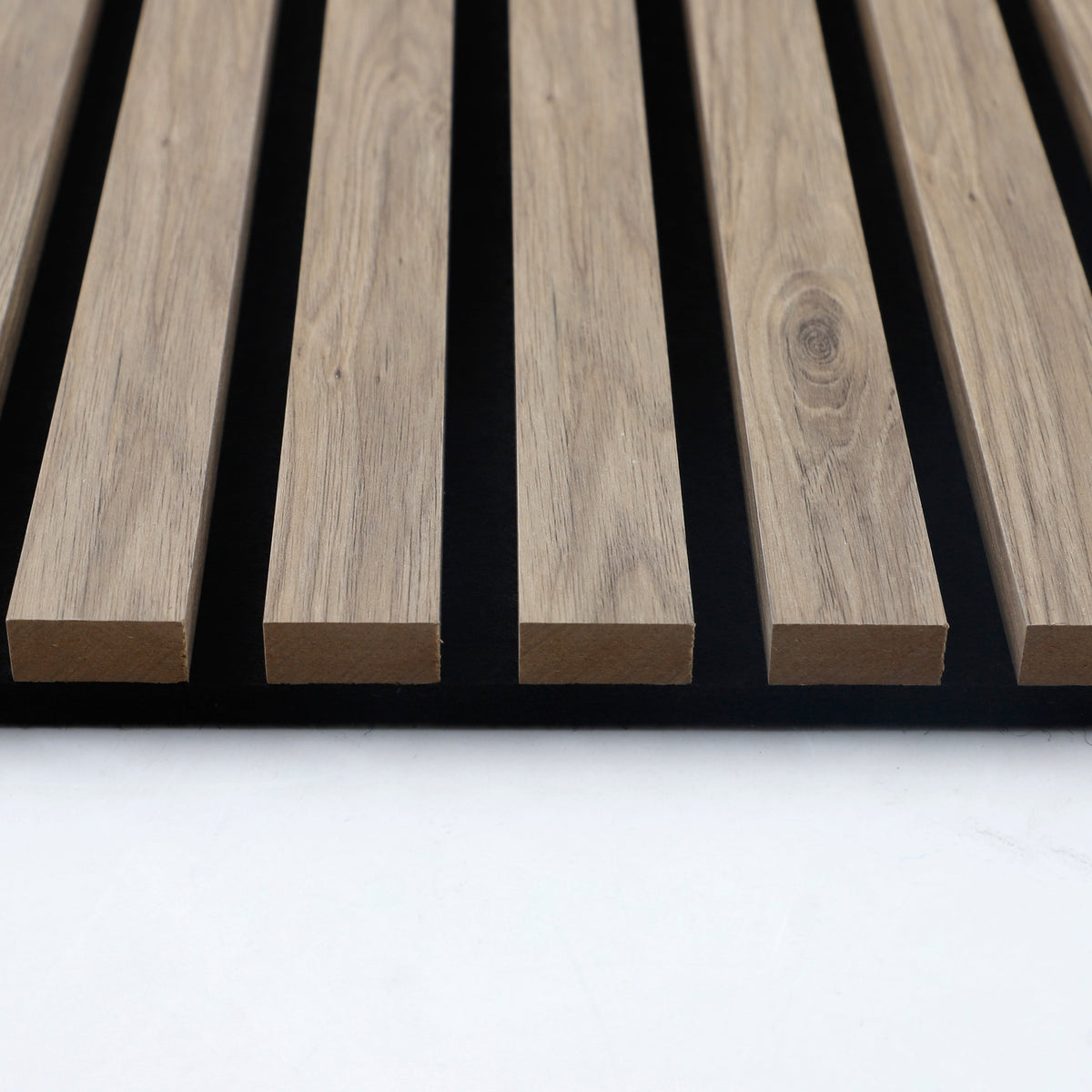 End view showing the wood slat profiles and black sound-absorbing panel backing