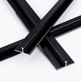 Overlapping lengths of black aluminum alloy H trim with exposed cross sections