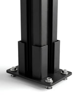 Close-up of the black above-ground fence post base plate secured with four bolts