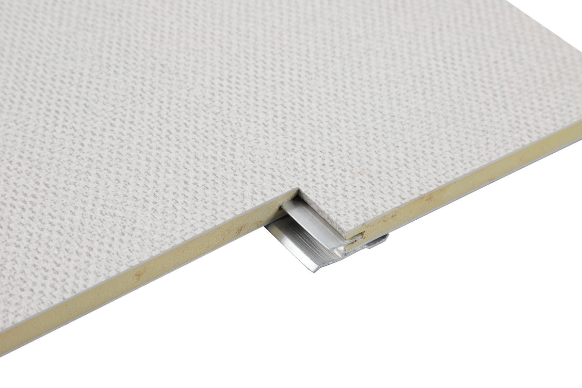 Aluminum invisible seamless trim connector fitted beneath two light textured panel edges