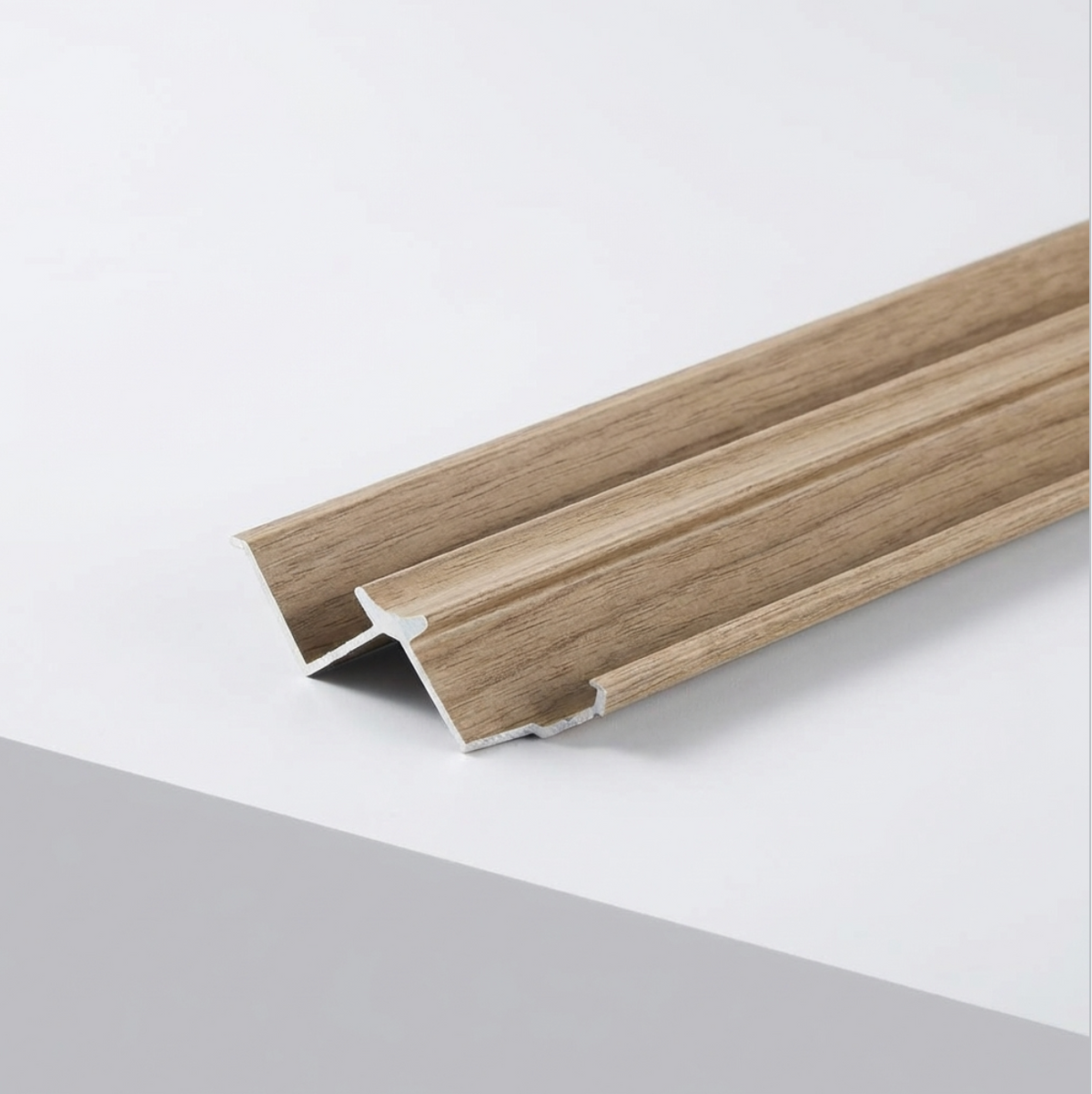Close-up of wood-look aluminum inside corner trim for ash veneer wall panels