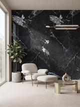 Black and white marble PVC wall panel accent wall behind a lounge chair and ottoman