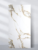 Calacatta Oro Gold 4 x 8 ft PVC wall panel with a white marble look and flowing gray and gold veining