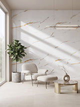 Caramel Vein PVC marble accent wall behind a lounge chair, ottoman, and indoor tree