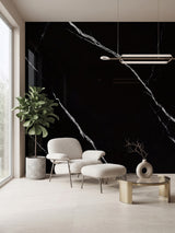 Deep Black Marble PVC wall panels with bold white veining behind a lounge chair and coffee table