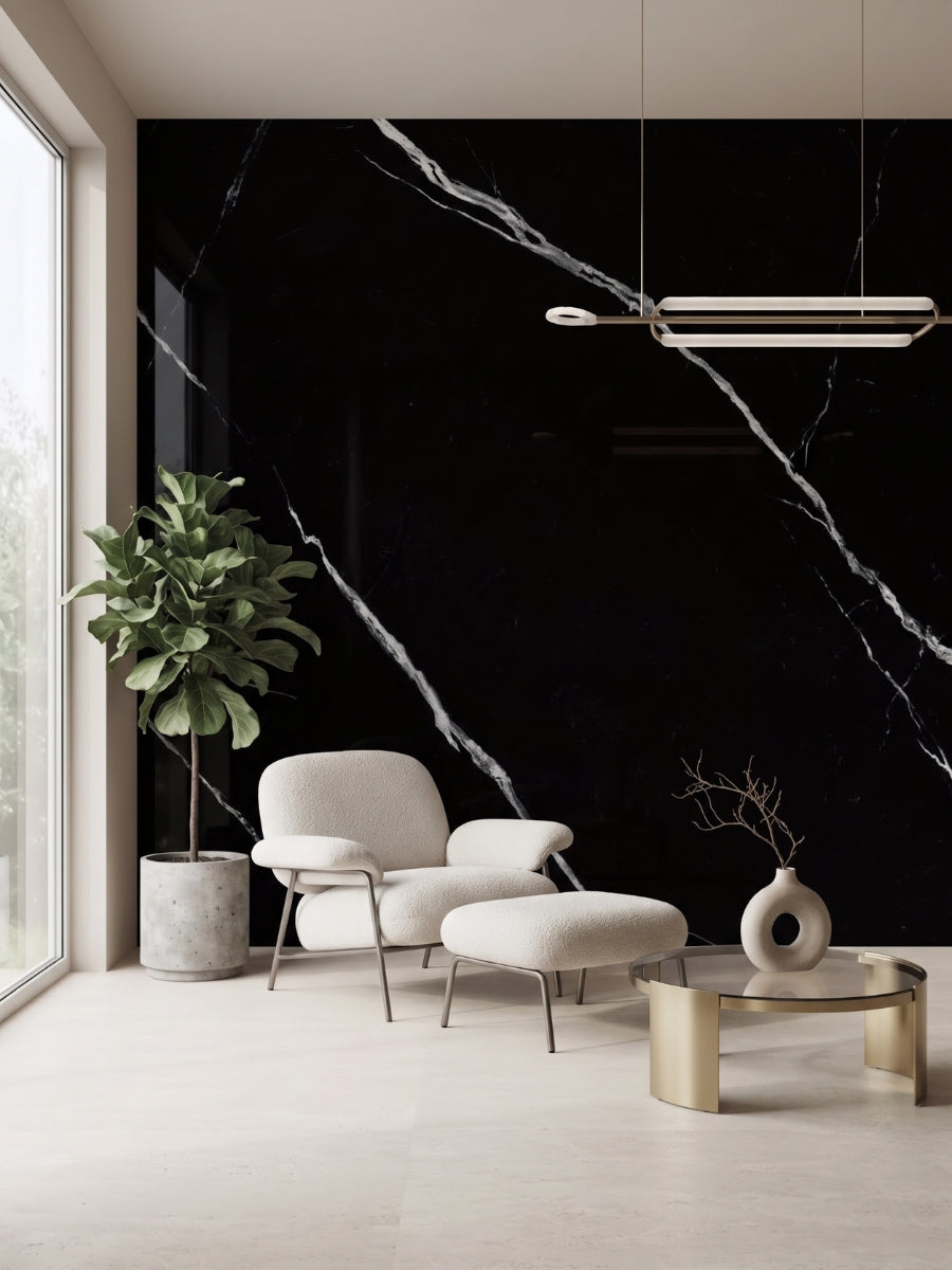 Deep Black Marble PVC wall panels with bold white veining behind a lounge chair and coffee table