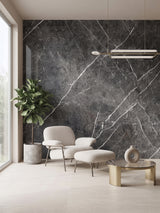 Dark gray marble PVC wall panel accent wall behind a lounge chair and ottoman