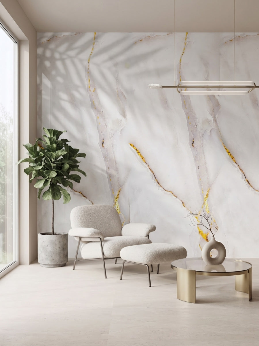 Empress Gold marble-style PVC wall panels with gray and gold veining in a bright lounge with an armchair and plant