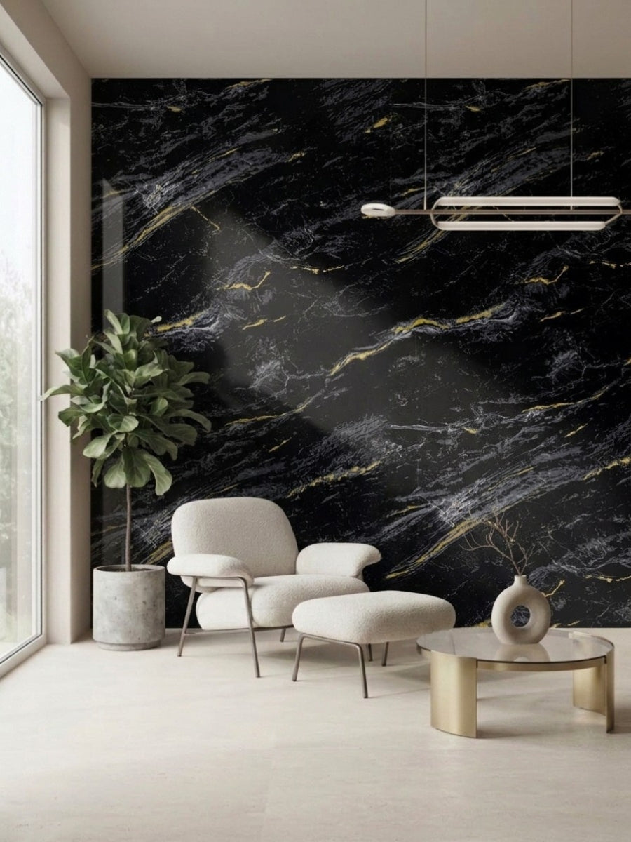 Midnight Gold Marble wall panel with white and gold veining behind a lounge chair, ottoman, and potted plant