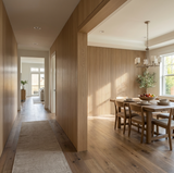 White oak veneer wall panels lining a hallway beside a dining room with a coordinating slatted wall