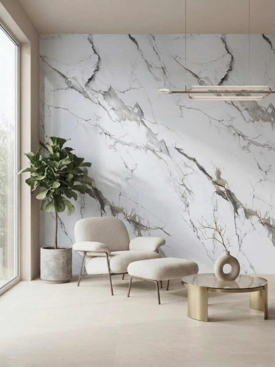 Moonlit Vein marble PVC wall panels installed behind a cream lounge chair, ottoman, plant, and round coffee table