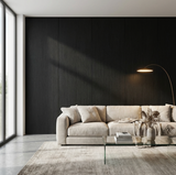 Blackwood veneer wall panels forming a dark vertical-grain feature wall behind a cream sofa