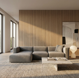 Ash wood veneer feature wall in a modern living room with a gray sectional sofa