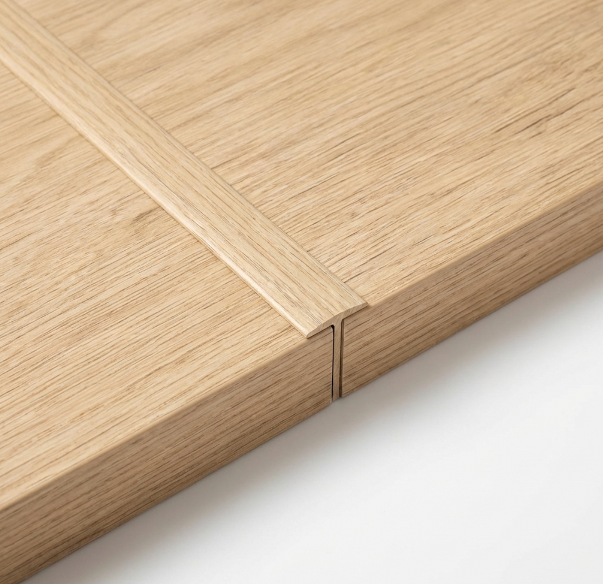 Close-up of two white oak veneer wall panels joined by a narrow matching trim strip