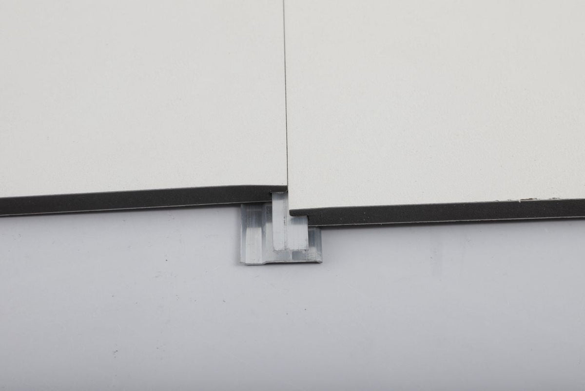 Aluminum invisible seamless trim connector installed between two white panel edges