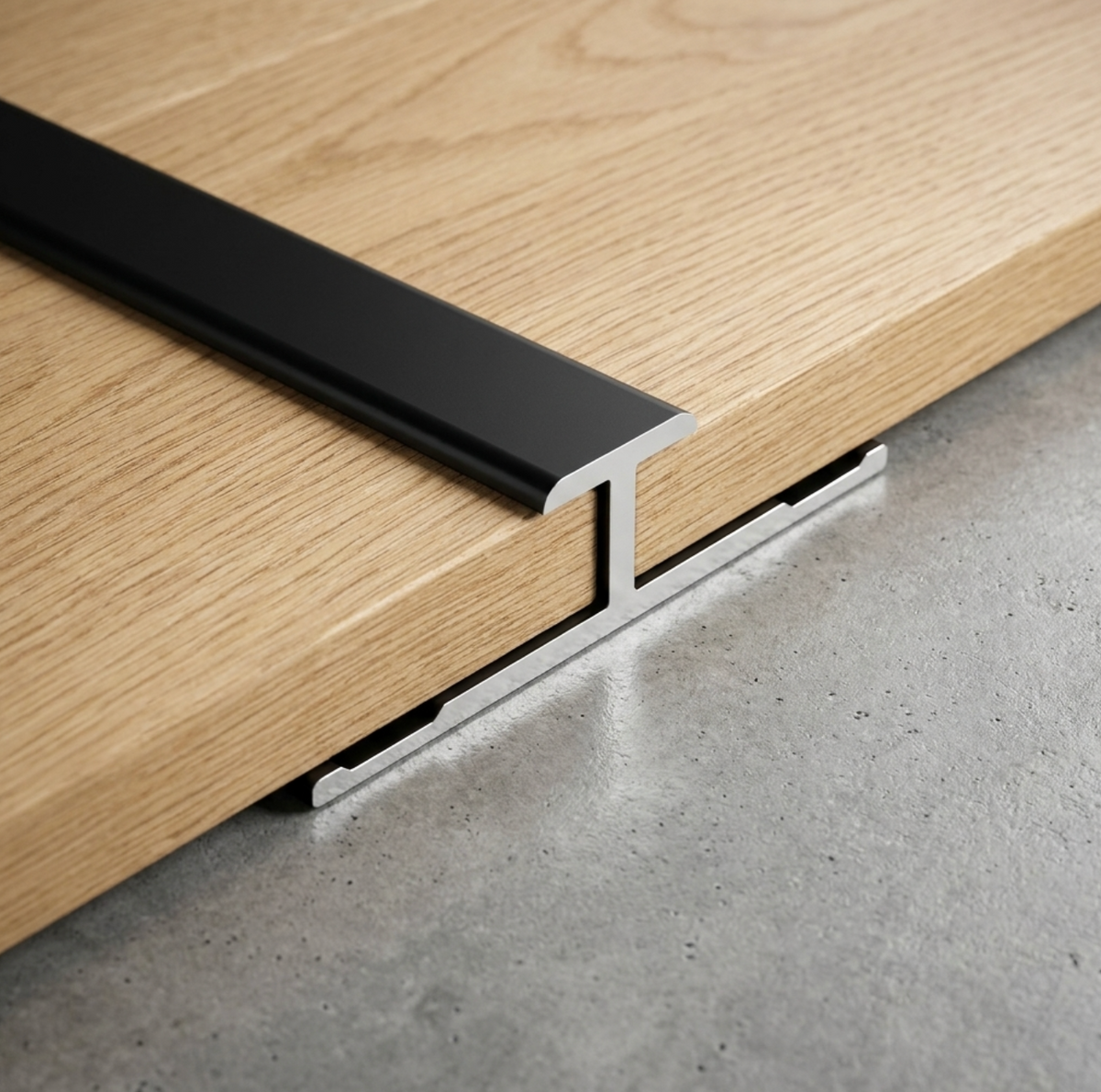 Black aluminum alloy H trim joining two wood-look panels on a gray surface