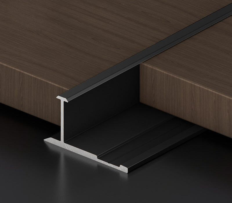 Black 3mm aluminum H-joint connection trim positioned between dark wood-look wall panels
