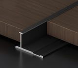 Black 3mm aluminum H-joint connection trim positioned between dark wood-look wall panels