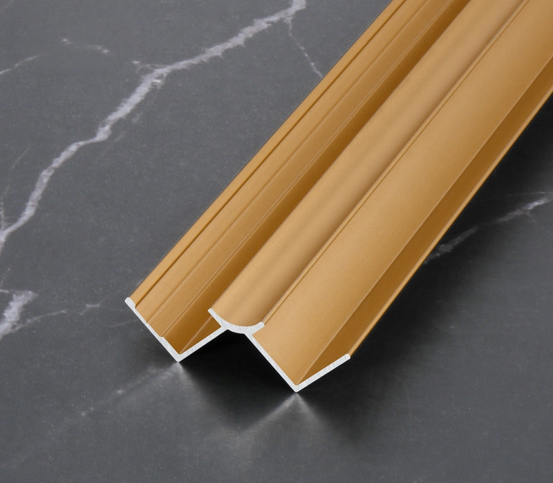 Gold 3mm aluminum inside corner trim profile showing the curved central groove