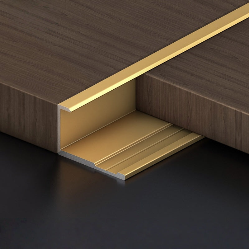Gold 3mm aluminum end cap trim fitted along a dark wood-look PVC wall panel edge