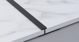 Black 3mm aluminum H-joint trim connecting two white marble-look PVC wall panels