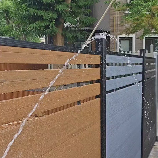 Brown composite fence with wood grain texture, supported by black metal posts, perfect for NJ backyards.